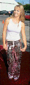 Pixellated Britney Spears is smiling on a red carpet while wearing some very sparkly trousers