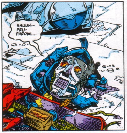 Optimus Prime is lying on the floor with his beautiful robot face ripped open.