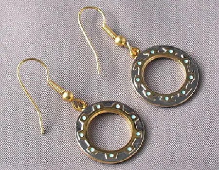 A pair of dangly chakram earrings, the height of geek fashion.